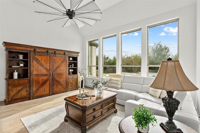 116 Egret Ln, Austin, TX 78737 - living area with light wood finished floors, vaulted ceiling, a chandelier, and baseboards