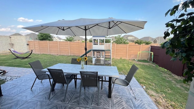 157 Monroe Dr, Kyle, TX 78640 - view of patio with outdoor dining area and a playground