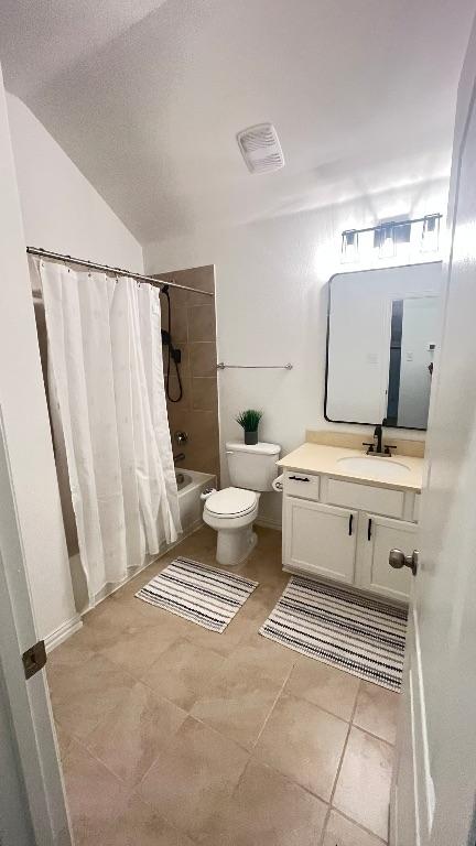 157 Monroe Dr, Kyle, TX 78640 - bathroom featuring shower / bath combo with shower curtain, toilet, vanity, and tile patterned flooring