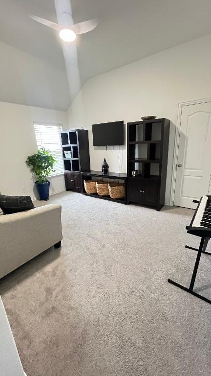 157 Monroe Dr, Kyle, TX 78640 - carpeted living room featuring ceiling fan and high vaulted ceiling