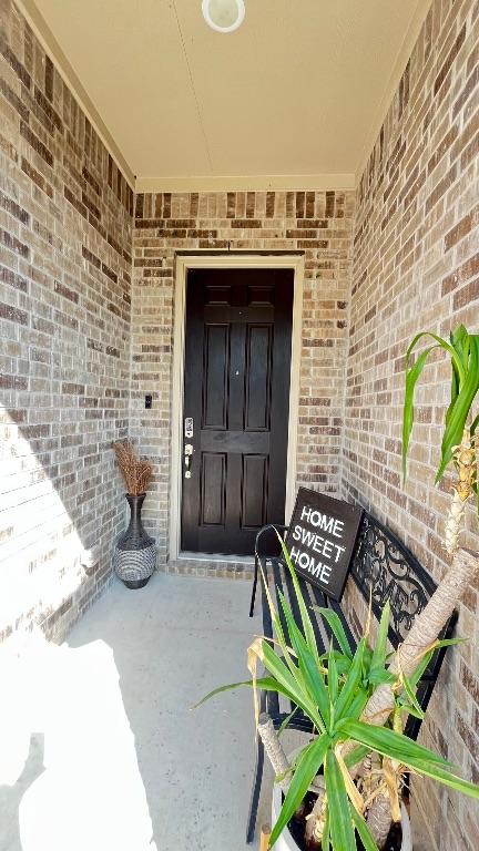 157 Monroe Dr, Kyle, TX 78640 - view of exterior entry with brick siding