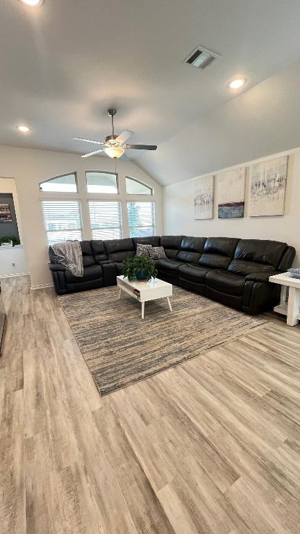 157 Monroe Dr, Kyle, TX 78640 - living area featuring vaulted ceiling, wood finished floors, and a ceiling fan