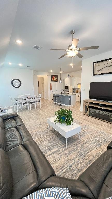 157 Monroe Dr, Kyle, TX 78640 - living room featuring ceiling fan, light wood-style floors, and recessed lighting