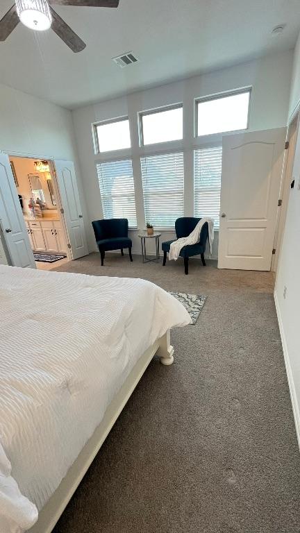 157 Monroe Dr, Kyle, TX 78640 - bedroom with multiple windows, carpet floors, and ceiling fan