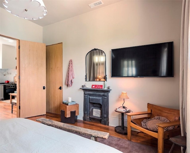 8608 Georgian Dr, Austin, TX 78753 - bedroom with wood finished floors and a fireplace