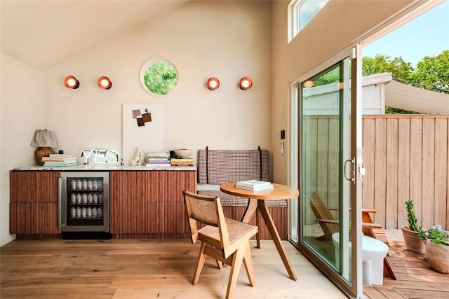 8608 Georgian Dr, Austin, TX 78753 - indoor bar featuring wine cooler, high vaulted ceiling, and light wood-style flooring