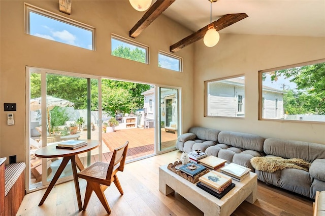 8608 Georgian Dr, Austin, TX 78753 - living area with high vaulted ceiling, light wood finished floors, and beamed ceiling