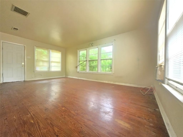121 E Guadalupe St, La Grange, TX 78945 - unfurnished room featuring healthy amount of natural light, wood finished floors, and baseboards