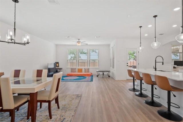 1305 Crescent Ln, Georgetown, TX 78633 - dining area with light wood finished floors, a chandelier, recessed lighting, a ceiling fan, and baseboards