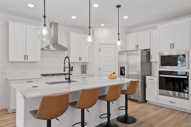 1305 Crescent Ln, Georgetown, TX 78633 - kitchen with appliances with stainless steel finishes, wall chimney range hood, light countertops, white cabinetry, and recessed lighting