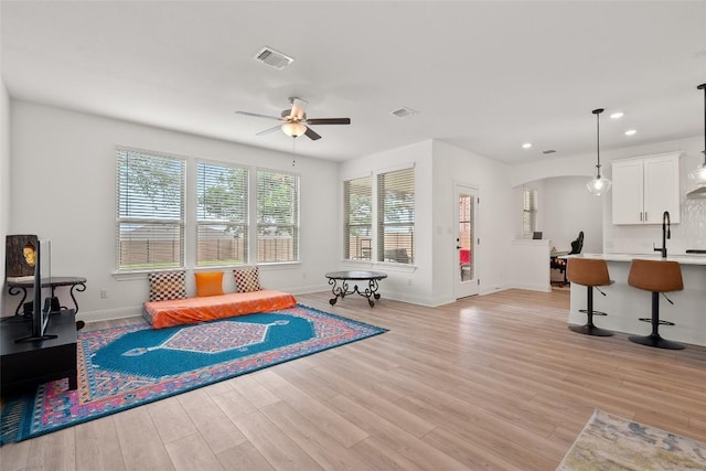 1305 Crescent Ln, Georgetown, TX 78633 - living area with a ceiling fan, light wood-style floors, arched walkways, baseboards, and recessed lighting