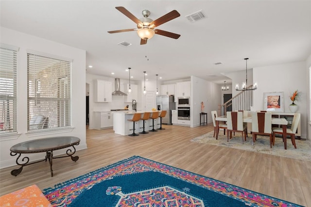 1305 Crescent Ln, Georgetown, TX 78633 - living room with light wood finished floors, a chandelier, a ceiling fan, and baseboards