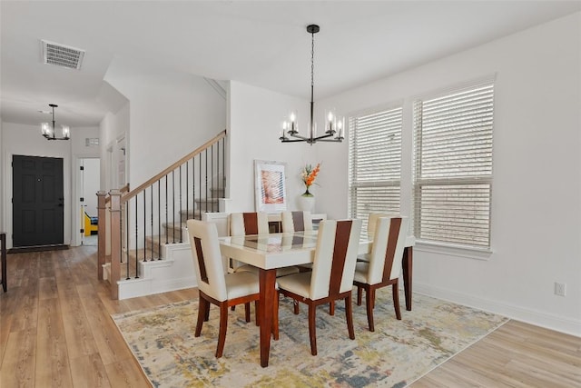 1305 Crescent Ln, Georgetown, TX 78633 - dining space with a chandelier, wood finished floors, and stairs