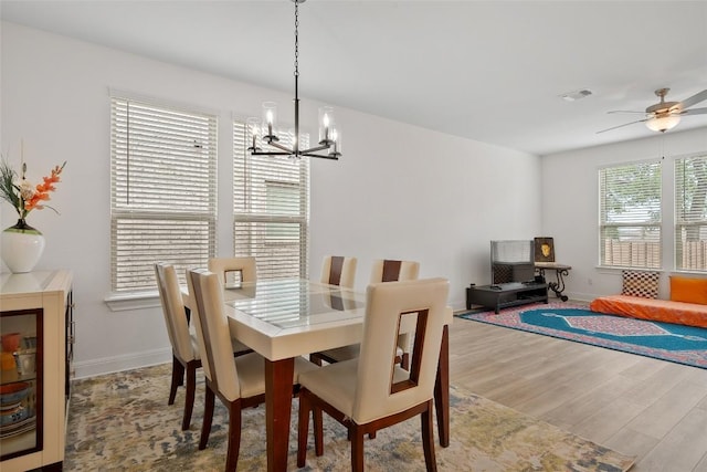 1305 Crescent Ln, Georgetown, TX 78633 - dining room with a chandelier, wood finished floors, a ceiling fan, and baseboards