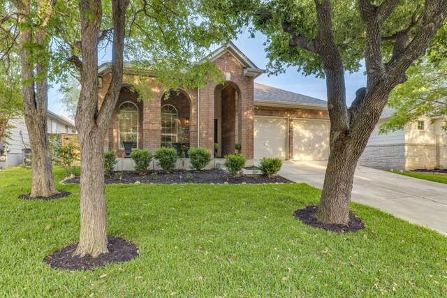 745 Bent Wood Pl, Round Rock, TX 78665 - traditional-style house featuring a garage, brick siding, concrete driveway, a front yard, and roof with shingles