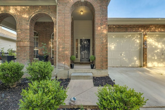 745 Bent Wood Pl, Round Rock, TX 78665 - view of exterior entry with brick siding, concrete driveway, and an attached garage