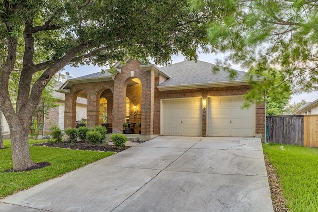 745 Bent Wood Pl, Round Rock, TX 78665 - traditional-style house featuring brick siding, a garage, driveway, and roof with shingles