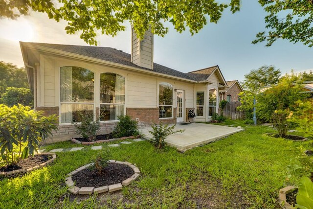 745 Bent Wood Pl, Round Rock, TX 78665 - rear view of property featuring a patio area, a chimney, and brick siding