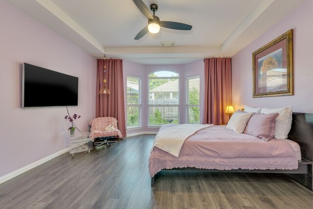 745 Bent Wood Pl, Round Rock, TX 78665 - bedroom featuring wood finished floors, baseboards, a ceiling fan, and a tray ceiling