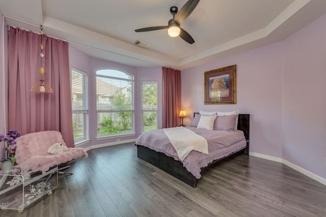 745 Bent Wood Pl, Round Rock, TX 78665 - bedroom featuring a raised ceiling, baseboards, dark wood-type flooring, and ceiling fan