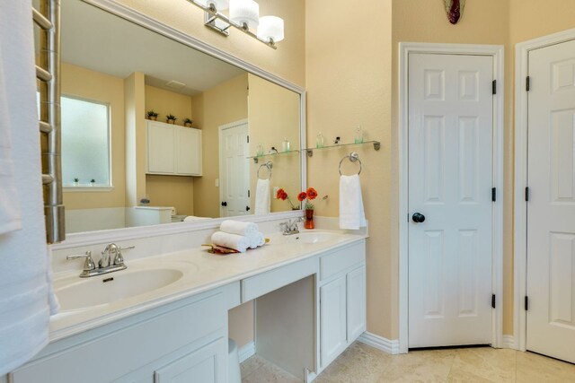 745 Bent Wood Pl, Round Rock, TX 78665 - full bathroom featuring double vanity, tile patterned floors, toilet, and baseboards