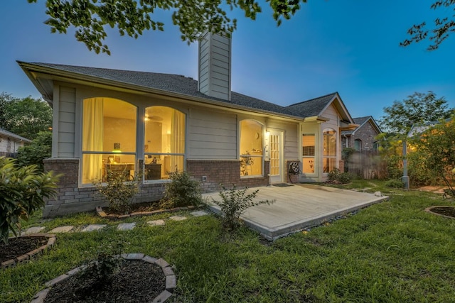 745 Bent Wood Pl, Round Rock, TX 78665 - rear view of house featuring brick siding, a chimney, and a patio area