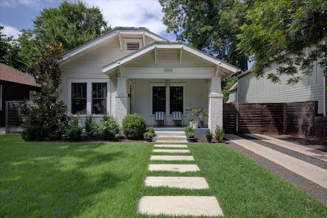 2504 Willow St Unit A, Austin, TX 78702 - view of front facade featuring covered porch and a front lawn