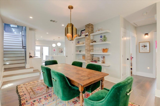 2504 Willow St Unit A, Austin, TX 78702 - dining room with wood finished floors, baseboards, stairway, and recessed lighting