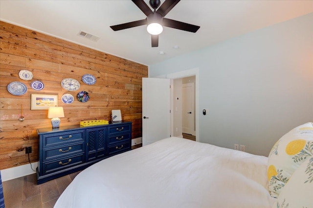 2504 Willow St Unit A, Austin, TX 78702 - bedroom featuring wood walls, dark wood-style flooring, and ceiling fan