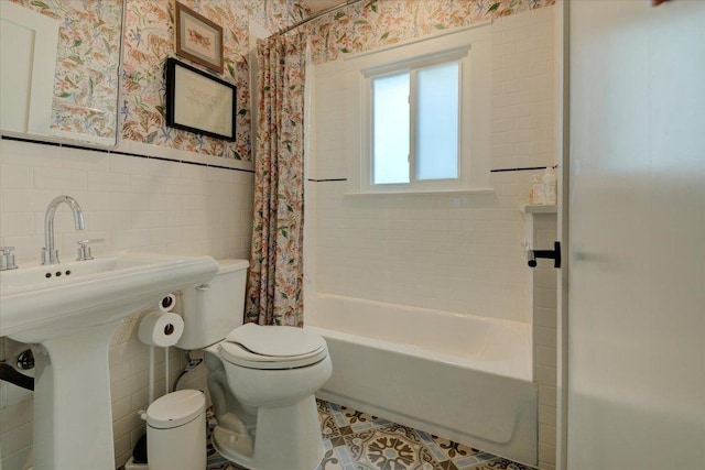 2504 Willow St Unit A, Austin, TX 78702 - full bath with wallpapered walls, tile walls, toilet, wainscoting, and shower / tub combo with curtain