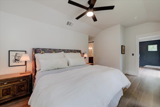 2504 Willow St Unit A, Austin, TX 78702 - bedroom featuring vaulted ceiling, dark wood-type flooring, ceiling fan, connected bathroom, and baseboards