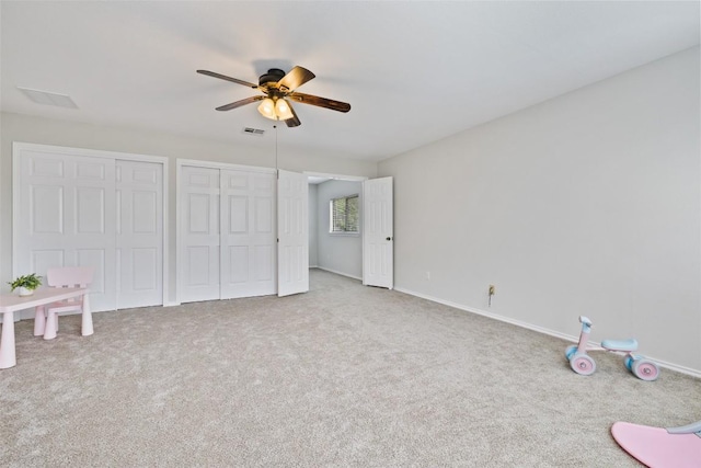 223 Woodlake Dr, Georgetown, TX 78633 - unfurnished bedroom with carpet, baseboards, two closets, and ceiling fan