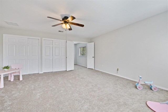 223 Woodlake Dr, Georgetown, TX 78633 - unfurnished bedroom with carpet, multiple closets, and ceiling fan
