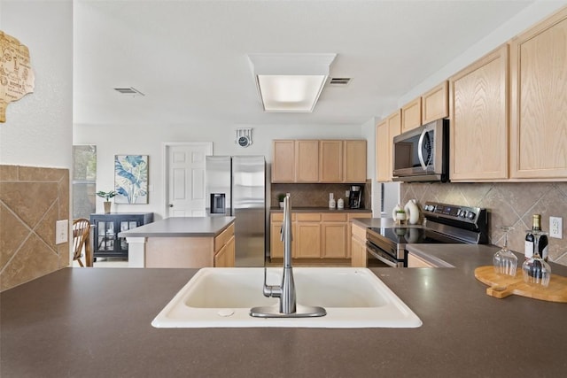 223 Woodlake Dr, Georgetown, TX 78633 - kitchen featuring stainless steel appliances, light brown cabinetry, a sink, dark countertops, and tasteful backsplash