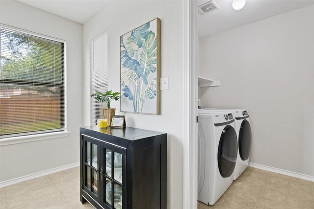 223 Woodlake Dr, Georgetown, TX 78633 - washroom featuring washer and clothes dryer, baseboards, and light tile patterned floors