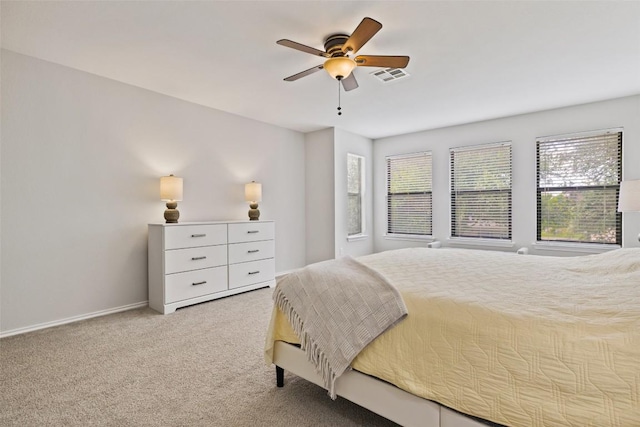 223 Woodlake Dr, Georgetown, TX 78633 - carpeted bedroom with multiple windows, a ceiling fan, and baseboards