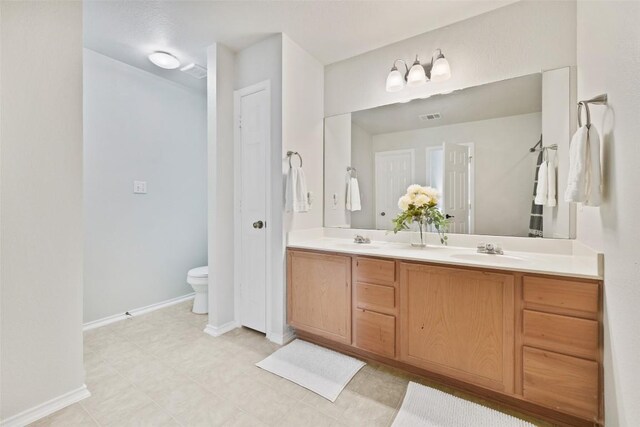 223 Woodlake Dr, Georgetown, TX 78633 - bathroom featuring double vanity and toilet