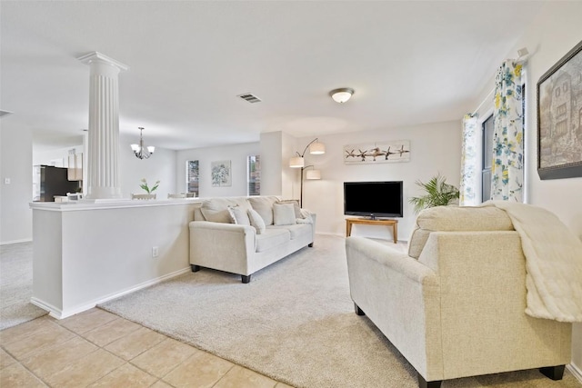 223 Woodlake Dr, Georgetown, TX 78633 - tiled living area featuring carpet, ornate columns, baseboards, and a chandelier