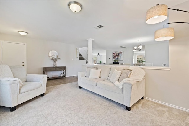 223 Woodlake Dr, Georgetown, TX 78633 - carpeted living room featuring baseboards, stairs, and ornate columns