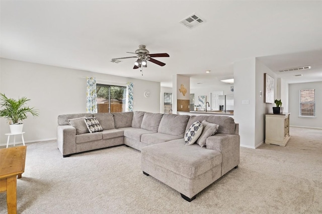 223 Woodlake Dr, Georgetown, TX 78633 - living room featuring light colored carpet, ceiling fan, and baseboards