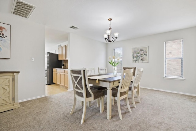 223 Woodlake Dr, Georgetown, TX 78633 - dining area with a chandelier, light colored carpet, and baseboards