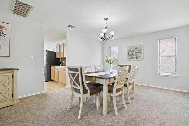 223 Woodlake Dr, Georgetown, TX 78633 - dining space with light colored carpet and a chandelier