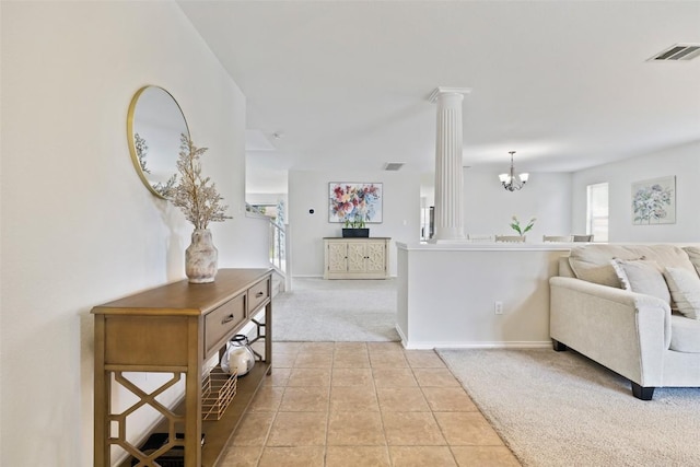223 Woodlake Dr, Georgetown, TX 78633 - living area featuring light carpet, decorative columns, a chandelier, light tile patterned flooring, and baseboards
