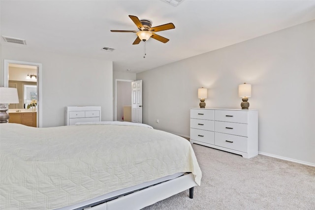 223 Woodlake Dr, Georgetown, TX 78633 - bedroom featuring light colored carpet, connected bathroom, and a ceiling fan