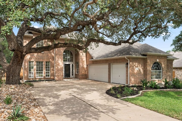 5708 Bexley Ct, Austin, TX 78739 - traditional home featuring a shingled roof, concrete driveway, brick siding, and a garage
