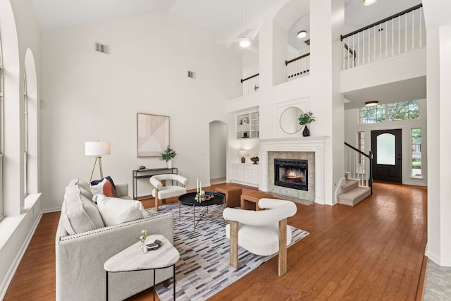 5708 Bexley Ct, Austin, TX 78739 - living area with built in shelves, high vaulted ceiling, wood finished floors, ceiling fan, and arched walkways