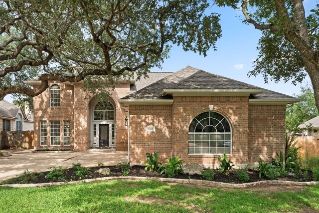 5708 Bexley Ct, Austin, TX 78739 - view of front of home with a shingled roof, brick siding, and a patio