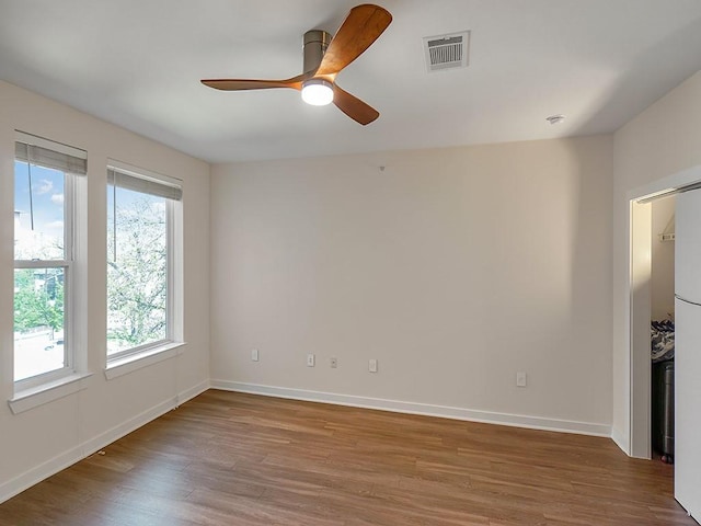 1900 Barton Springs Rd Unit 4013, Austin, TX 78704 - spare room featuring wood finished floors, baseboards, and a ceiling fan
