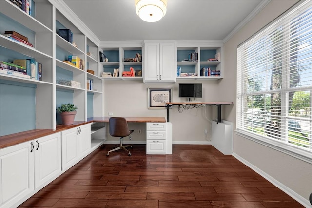 5929 Mesa Verde Cir, Austin, TX 78749 - home office with built in desk, dark wood finished floors, crown molding, and baseboards