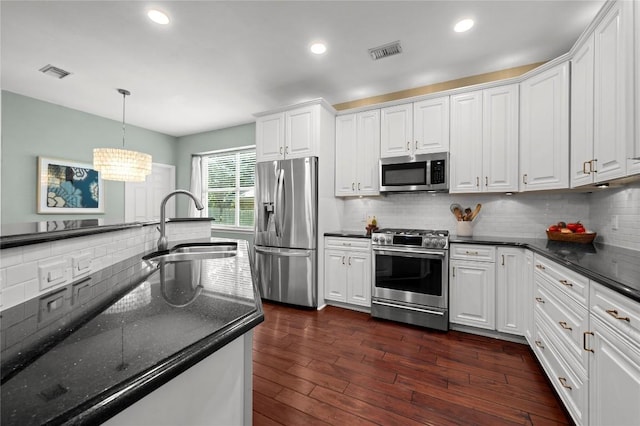 5929 Mesa Verde Cir, Austin, TX 78749 - kitchen with stainless steel appliances, a sink, decorative backsplash, white cabinetry, and recessed lighting